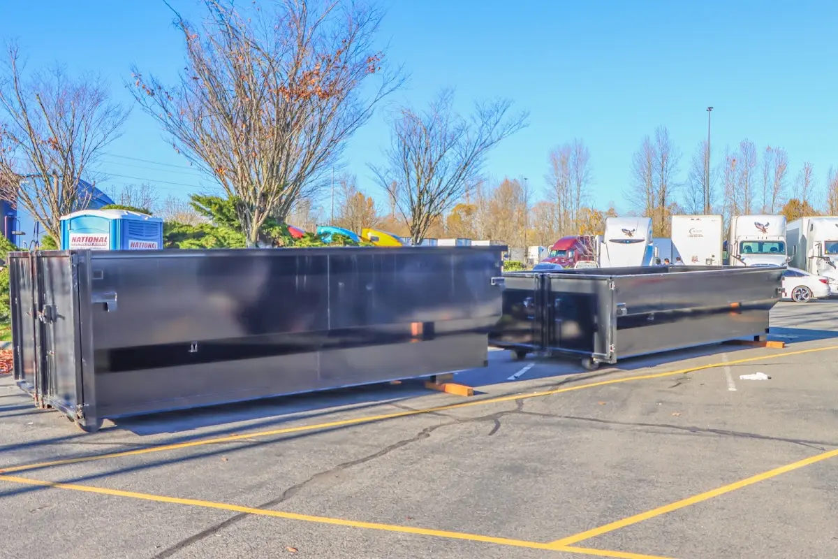 Professional dumpster rental service with roll-off container on residential driveway in Poplar Bluff